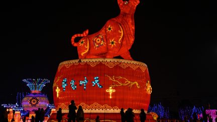 TOPSHOT - People look at a giant ox lantern in a park in Wuhan in China's central Hubei province on February 11, 2021, ahead of the start of the Lunar New Year, which ushers in the Year of the Ox on February 12. (Photo by Hector RETAMAL / AFP) (Photo by HECTOR RETAMAL/AFP via Getty Images)