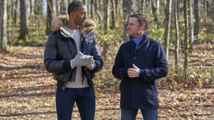 Chris Harrison and Bachelor Matt James stand in the woods, looking at each other.