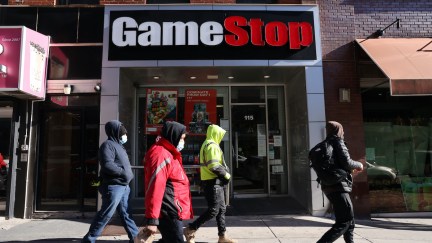 People walk by a GameStop store in Brooklyn