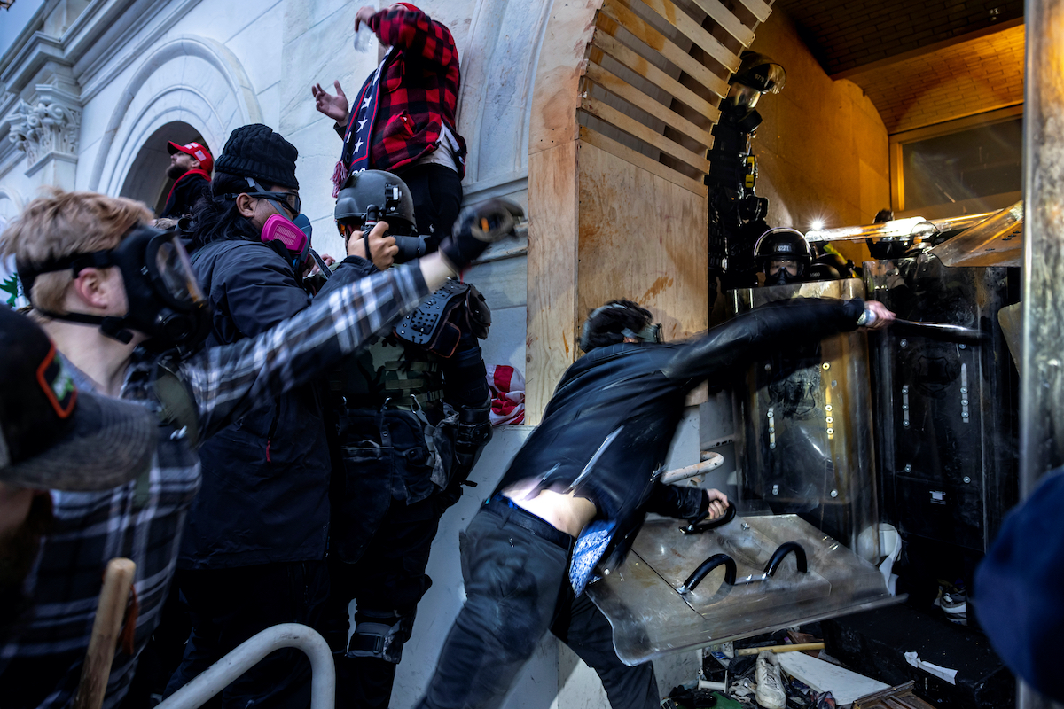 Pro-Trump rioters try to break into the U.S. Capitol as police hold them off with plastic shields.