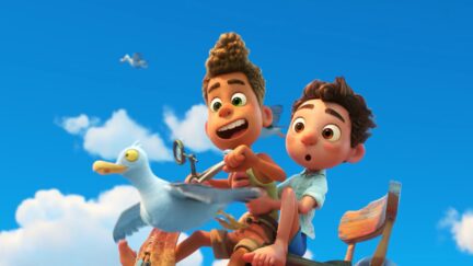 two poys ride a bike in the sky through seagulls in luca