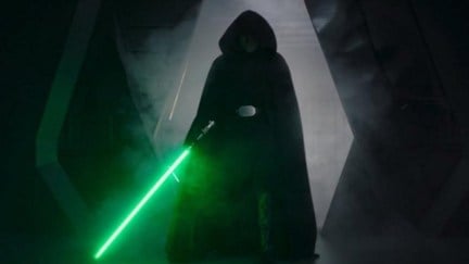 Luke Skywalker holding his lightsaber, on his way to save Grogu in The Mandalorian's 