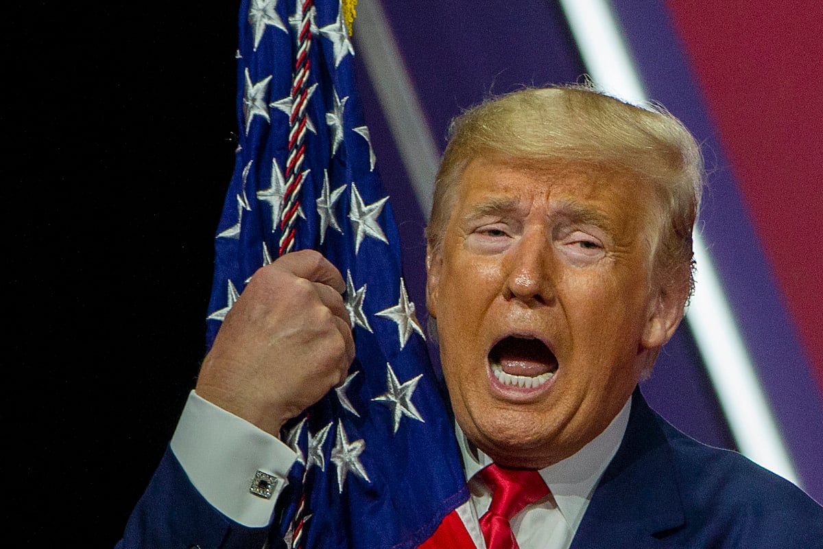 Donald Trump hugs a US flag and yells