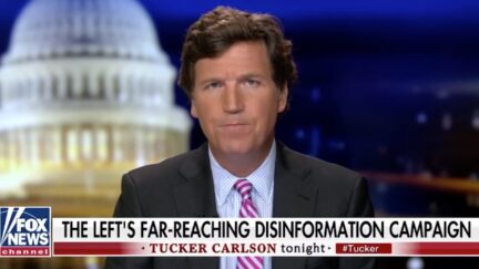 Tucker Carlson looks confused, as usual, above a chyron reading 