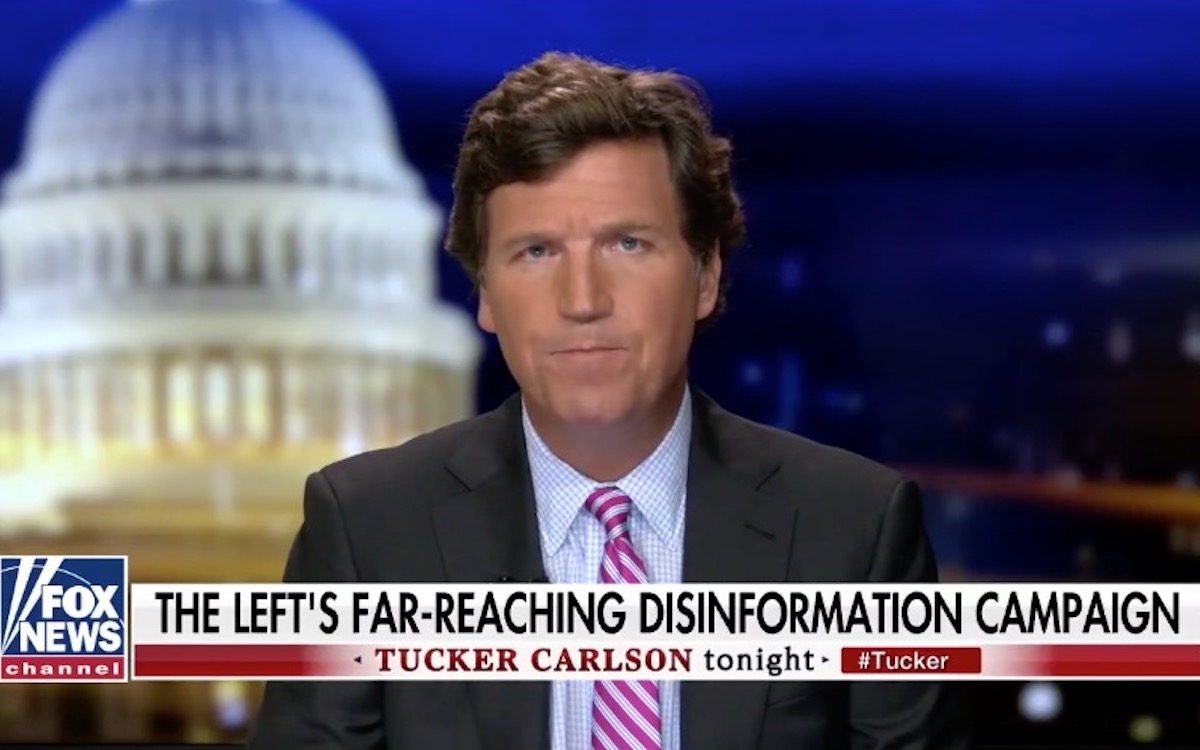 Tucker Carlson looks confused, as usual, above a chyron reading "The Left's Far-Reaching Disinformation Campaign."