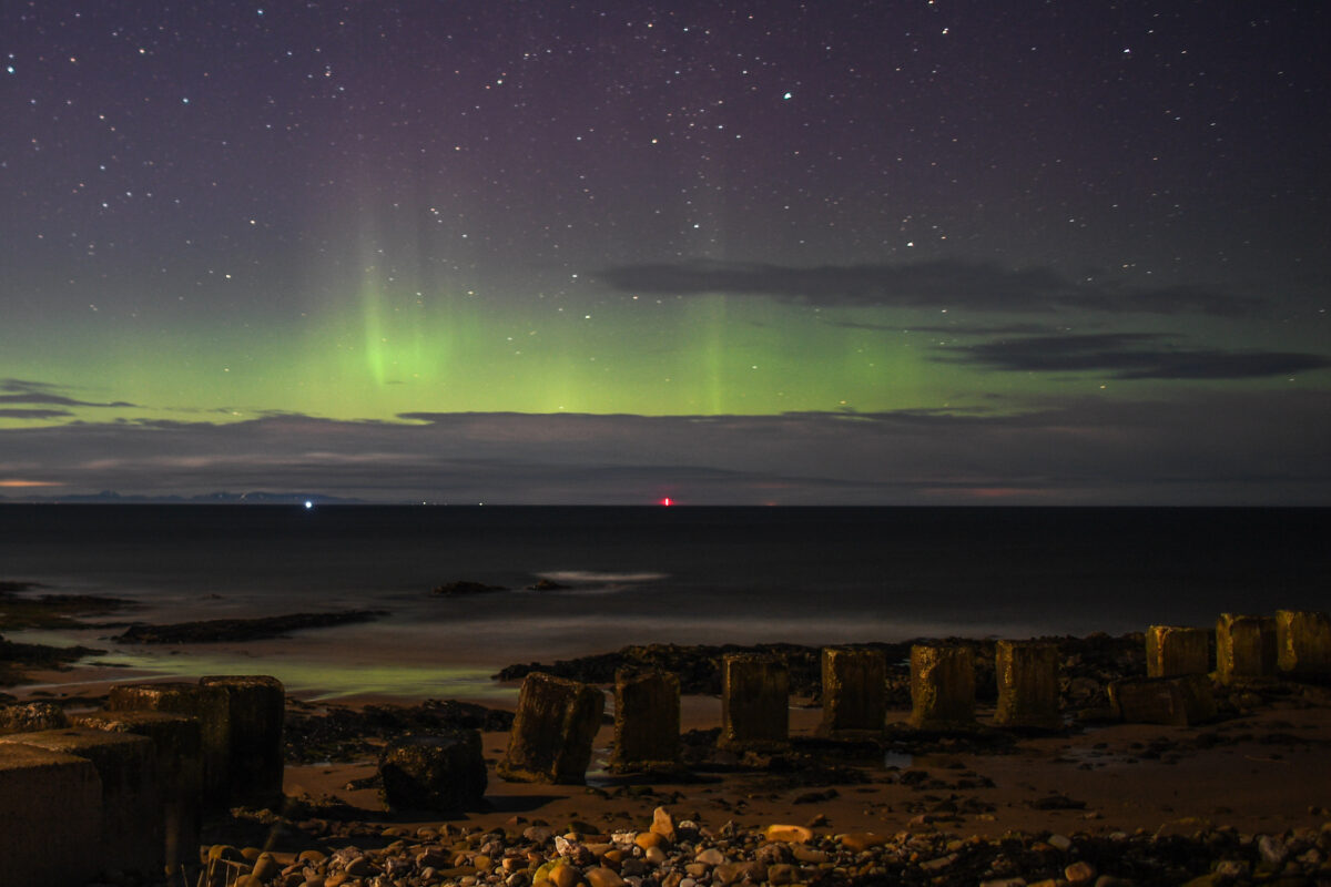LOSSIEMOUTH, SCOTLAND - FEBRUARY 20: The Aurora Borealis is seen above WW2 beach defenses on February 20, 2021 in Lossiemouth, Scotland. The Aurora Borealis, more commonly known as the Northern Lights, occurs when solar winds drive charged particles from the sun which strike atoms and molecules in Earths atmosphere causing the light show. (Photo by Peter Summers/Getty Images)