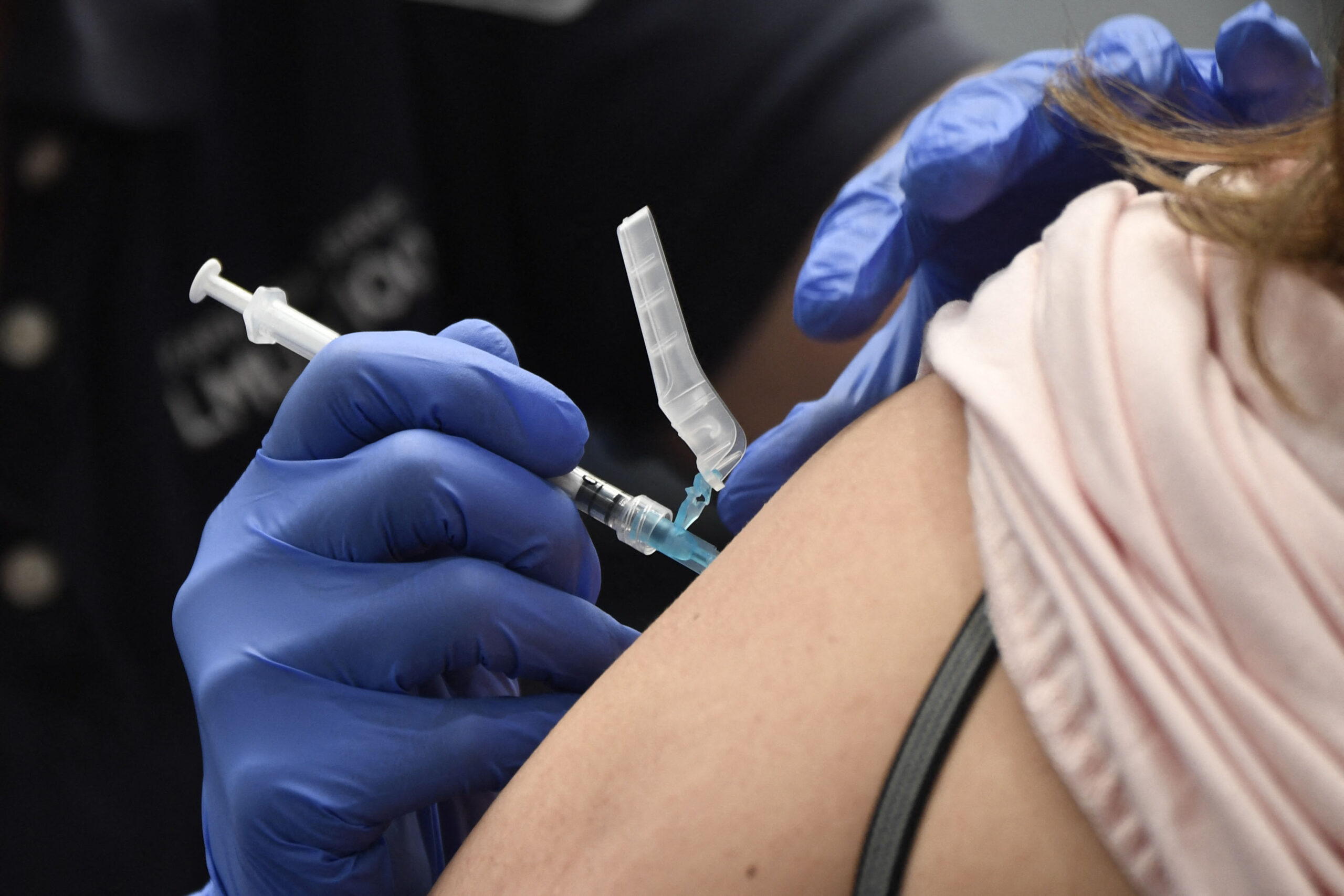 A nurse practitioner administers a dose of the Moderna Covid-19 vaccine at a clinic for Catholic school education workers including elementary school teachers and staff at a vaccination site at Loyola Marymount University (LMU) on March 8, 2021 in Los Angeles, California. (Photo by Patrick T. FALLON / AFP) (Photo by PATRICK T. FALLON/AFP via Getty Images)
