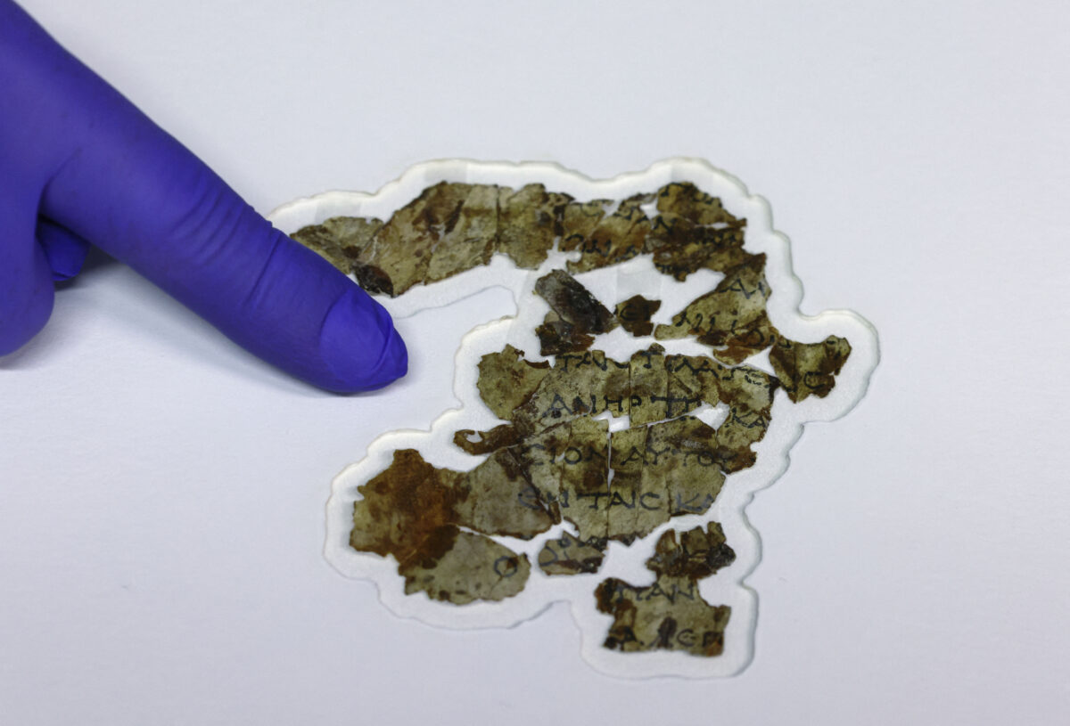 Israel Antiquities Authority (IAA) conservator Tanya Bitler displays recently-discovered 2000-year-old biblical scroll fragments from the Bar Kochba period, after completion of preservation work at the authority's Dead Sea conservation lab in Jerusalem, on March 16, 2021. - Israel described the find, which includes a cache of rare coins, a six-millennia-old skeleton of a child and basket it described as the oldest in the world, at over 10,000 years, as one of the most significant since the Dead Sea Scrolls. The fragments, found following a survey in a desert area spanning southern Israel and the occupied West Bank, include passages in Greek from the Book of the Twelve Minor Prophets including the books of Zechariah and Nahum, the IAA said. (Photo by MENAHEM KAHANA / AFP) (Photo by MENAHEM KAHANA/AFP via Getty Images)