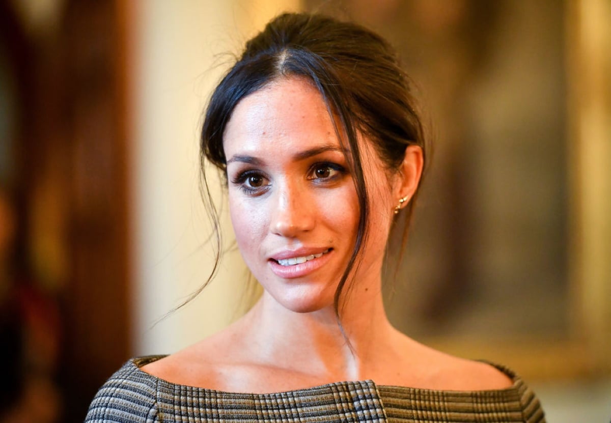 Meghan Markle chats with people inside the Drawing Room during a visit to Cardiff Castle.