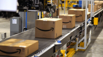 Packed orders move down a converyor belt at the Amazon fullfillment center