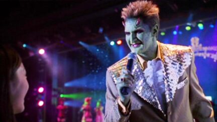 Andy Hallett as Lorne on Angel, singing into a microphone.