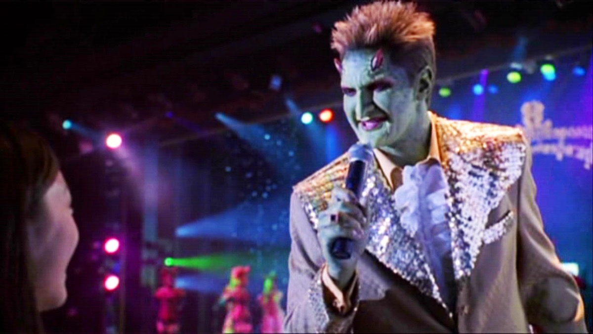 Andy Hallett as Lorne on Angel, singing into a microphone.