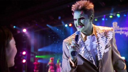 Andy Hallett as Lorne on Angel, singing into a microphone.