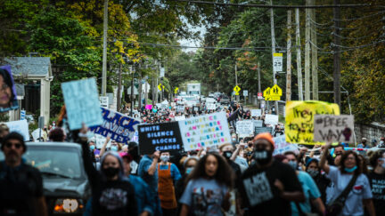 A group of protesters gather in the street in a march to the Breonna Taylor memorial