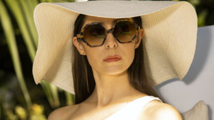 Cristin Milioti as Hazel Green in Made for Love, wearing large sunglasses and a giant white sun hat.