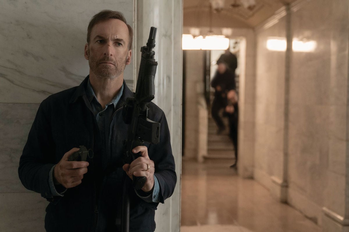 Bob Odenkirk holds an assault rifle in Nobody