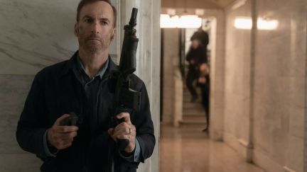 Bob Odenkirk holds an assault rifle in Nobody