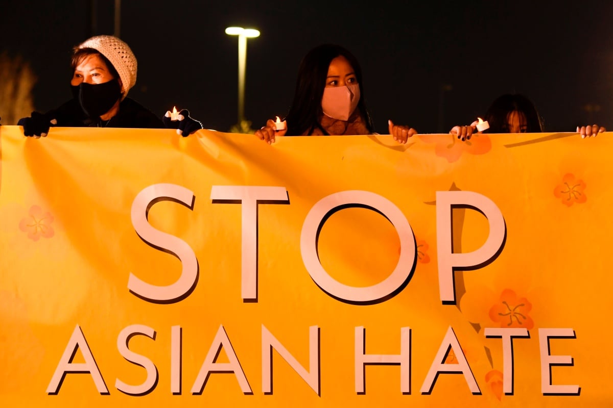 People hold lights during a vigil organized by Nailing It For America for those who have died from Covid-19 and to "Stop Asian Hate" on March 4, 2021 in Fountain Valley, California. - Orange County community volunteers formed the message of "Stop Asian Hate" with luminaries as reports of hate crimes against Asian Americans have increased since the beginning of the Covid-19 pandemic. (Photo by Patrick T. FALLON / AFP) (Photo by PATRICK T. FALLON/AFP via Getty Images)