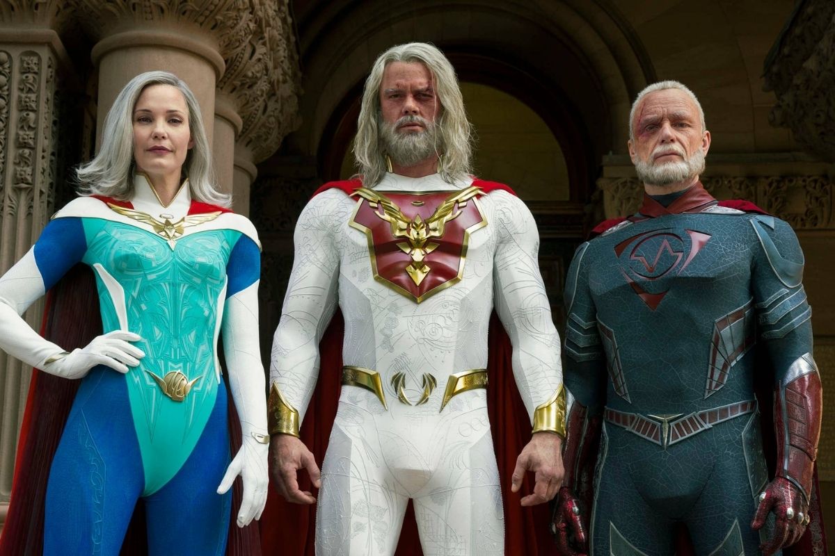 Netflix's Jupiter's Legacy cast Leslie Bibb, Josh Duhamel, and Ben Daniels standing in their characters' superhero uniforms.
