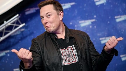 Elon Musk poses at a space event