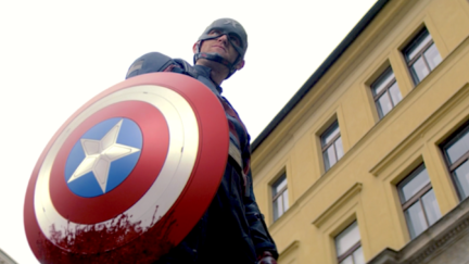 Wyatt Russell holds a bloody Captain America shield as John Walker on the Falcon and the Winter Soldier