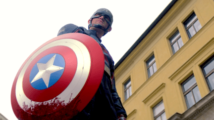 Wyatt Russell holds a bloody Captain America shield as John Walker on the Falcon and the Winter Soldier