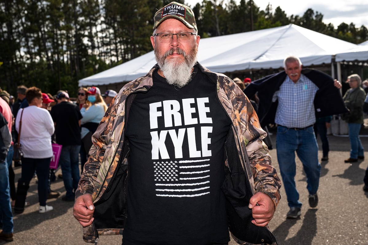 A man wears a Trump hat and a shirt that says "Free Kyle", referencing Kyle Rittenhouse