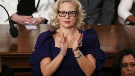 (image: Mario Tama/Getty Images) Sen. Krysten Sinema (D-AZ) applauds during the State of the Union