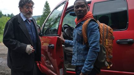 Alfred Molina and David Oyelowo stand next to a truck in the Water Man