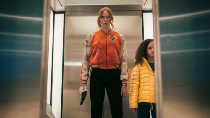 Karen Gillan and Chloe Coleman standing in an elevator in Gunpowder Milkshake