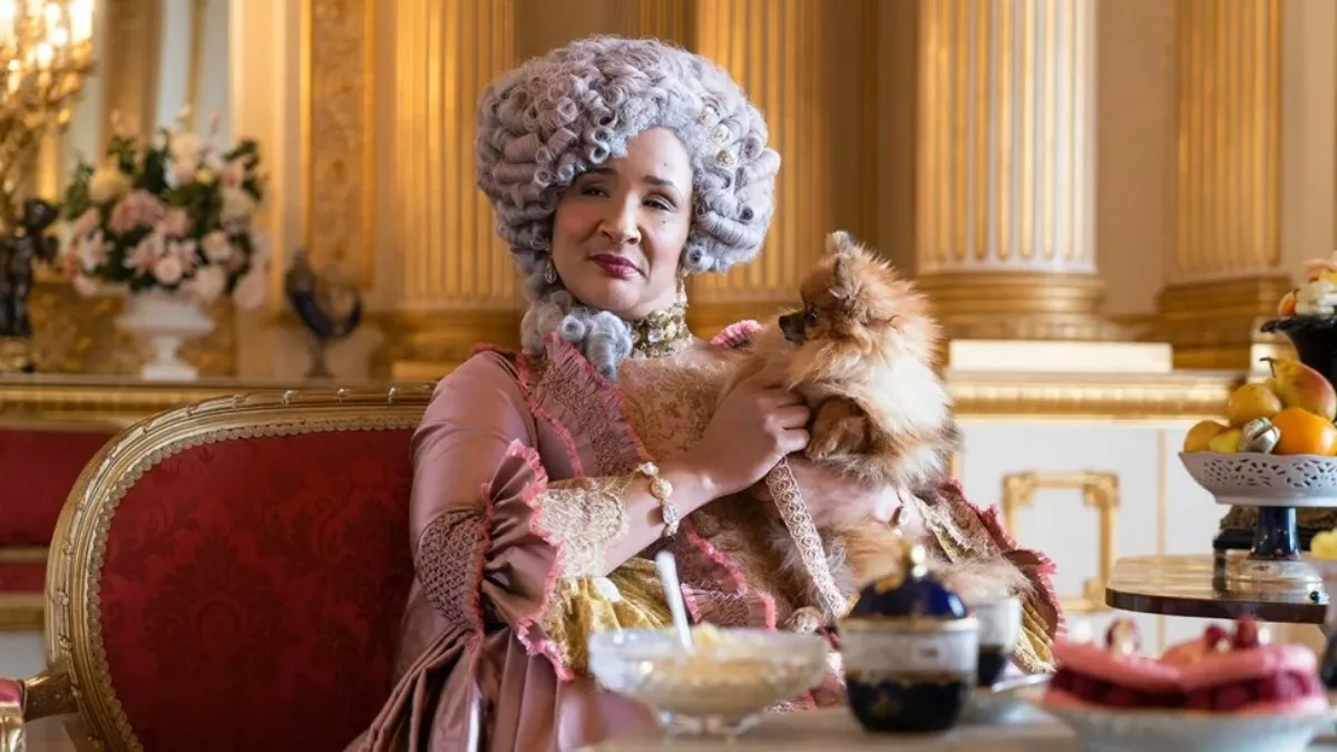 Golda Rosheuvel as Queen Charlotte in Bridgerton with a doggo