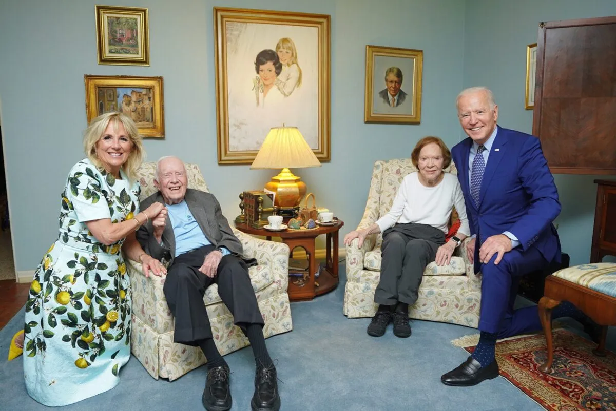 The Bidens and the Carters sitting together, with distorted perspective making the Bidens look giant.