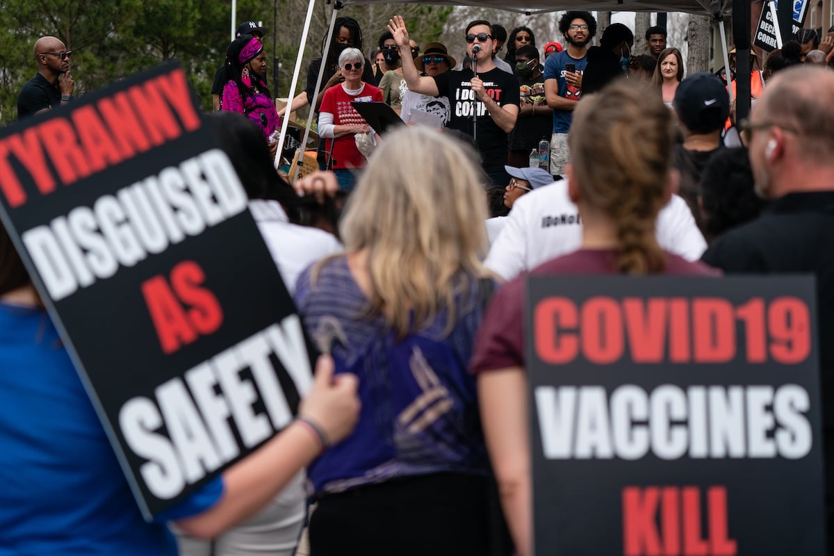 People are seen at a protest against masks, vaccines, and vaccine passports