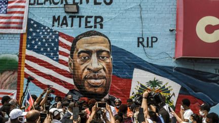 A colorful mural painted in memory of George Floyd by artist Kenny Altidor