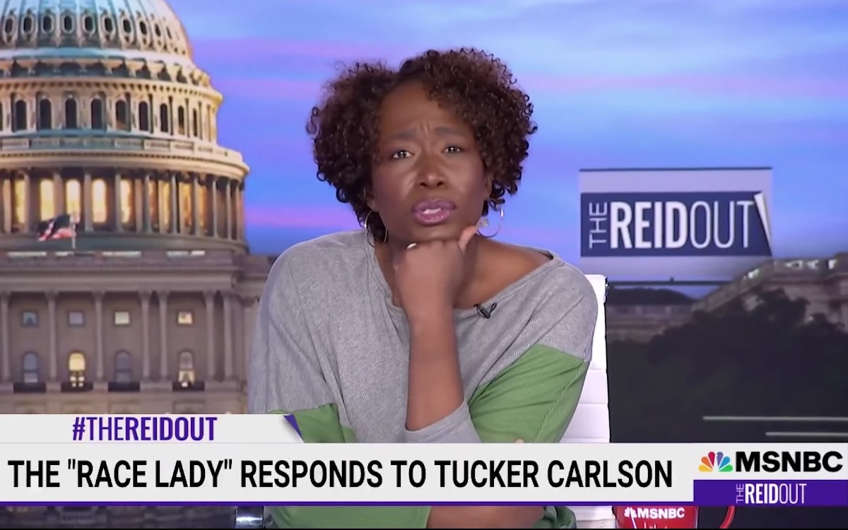 Joy Reid rests her chin on her hand above a chyron reading 'The 'race lady' responds to Tucker Carlson'"