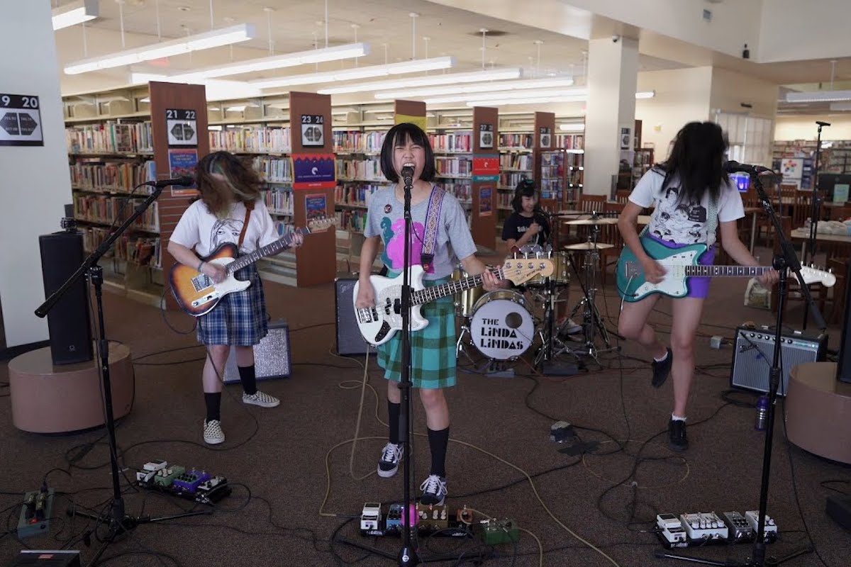 The Linda Lindas, four teenage girls, perform in a library