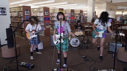 The Linda Lindas, four teenage girls, perform in a library