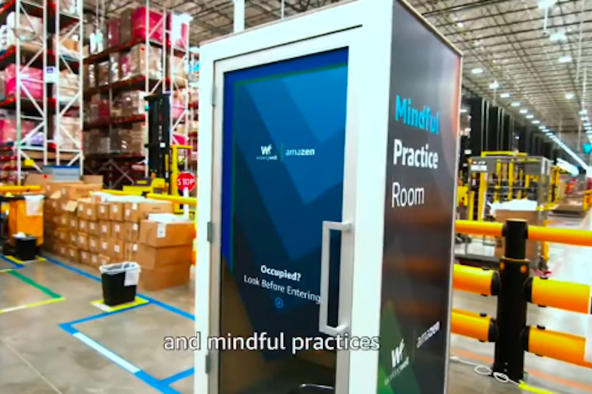 a booth in the middle of an Amazon Warehouse labeled "Mindful Practice Room"