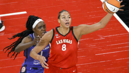 Liz Cambage #8 of the Las Vegas Aces catches a pass under pressure from Beatrice Mompremier #1 of the Connecticut Sun during their game