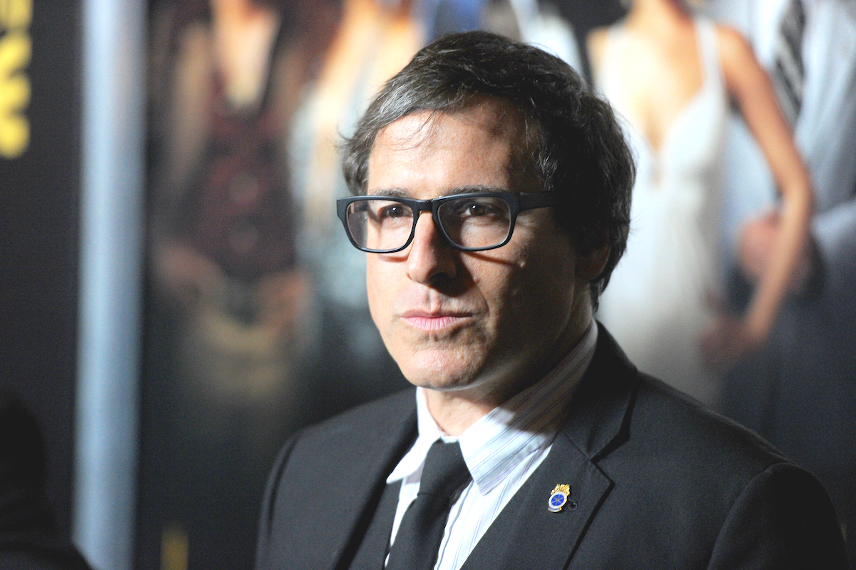 David O Russell stares expressionless on a red carpet