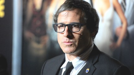David O Russell stares expressionless on a red carpet