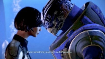 Shepard and Garrus leaning in close to talk in Mass Effect 2.