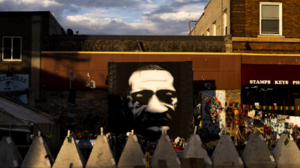 Sunlight falls on a portrait of George Floyd at George Floyd Square