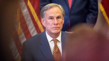 Texas Governor Greg Abbott listens during a press conference