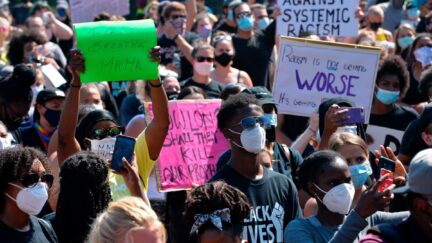 Protesters gather at the State House during a Juneteenth protest and march in honor of Rayshard Brooks and other victims of Police Violence in Boston, Massachusetts on June 22, 2020. (Photo by Joseph Prezioso / AFP) (Photo by JOSEPH PREZIOSO/AFP via Getty Images)