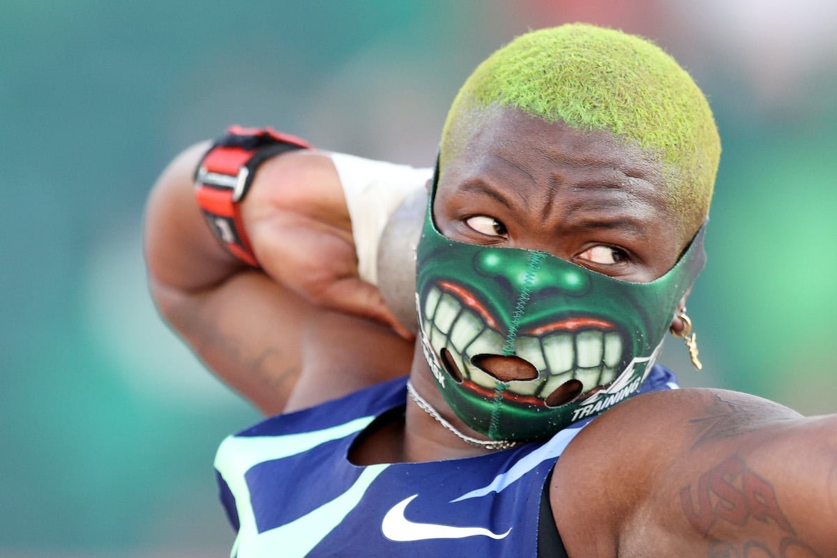 Raven Saunders wears a Hulk mask with dyed green shaved hair while throwing a shot put during the Olympic trials.