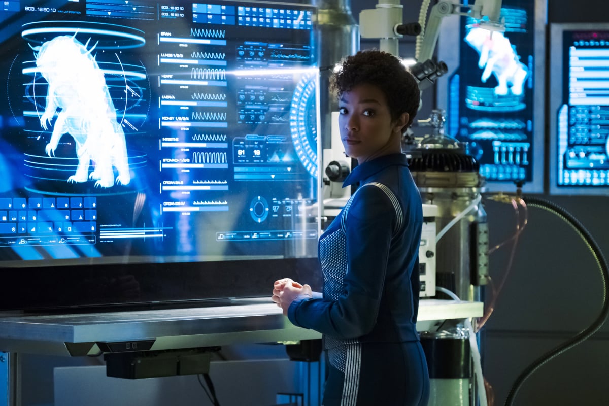 Michael Burnham stands before a monitor showing a giant tardigrade on Star Trek: Discovery