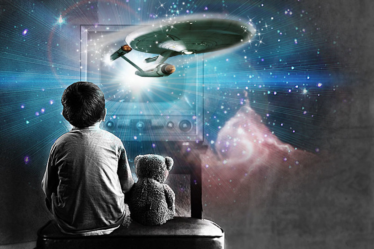 A child sits with a teddy bear watching television as the starship enterprise and celestial images hover around them