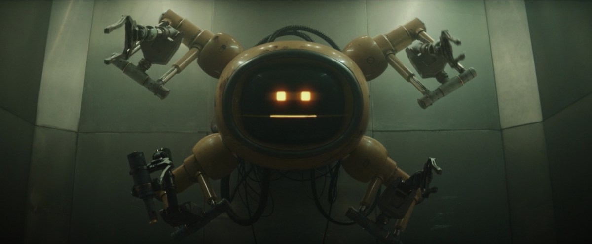 A robot with four arms and a round face made up of two square lights and a line.
