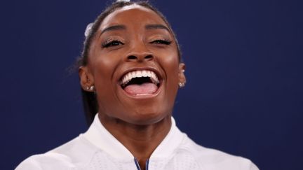 Simone Biles cheering on her teammates at the Tokyo Olympics.